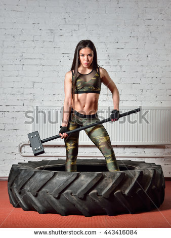 stock-photo-fit-woman-with-huge-hammer-posing-in-gym-443416084.jpg